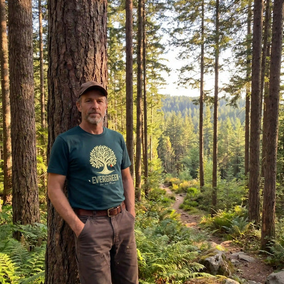 Man in forest wearing eco-friendly Evergreen T-shirt, nature apparel for outdoor adventures and sustainability.