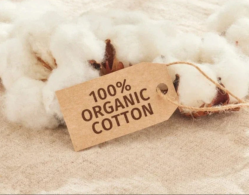 Cotton with a '100% Organic Cotton' tag on a soft, beige background